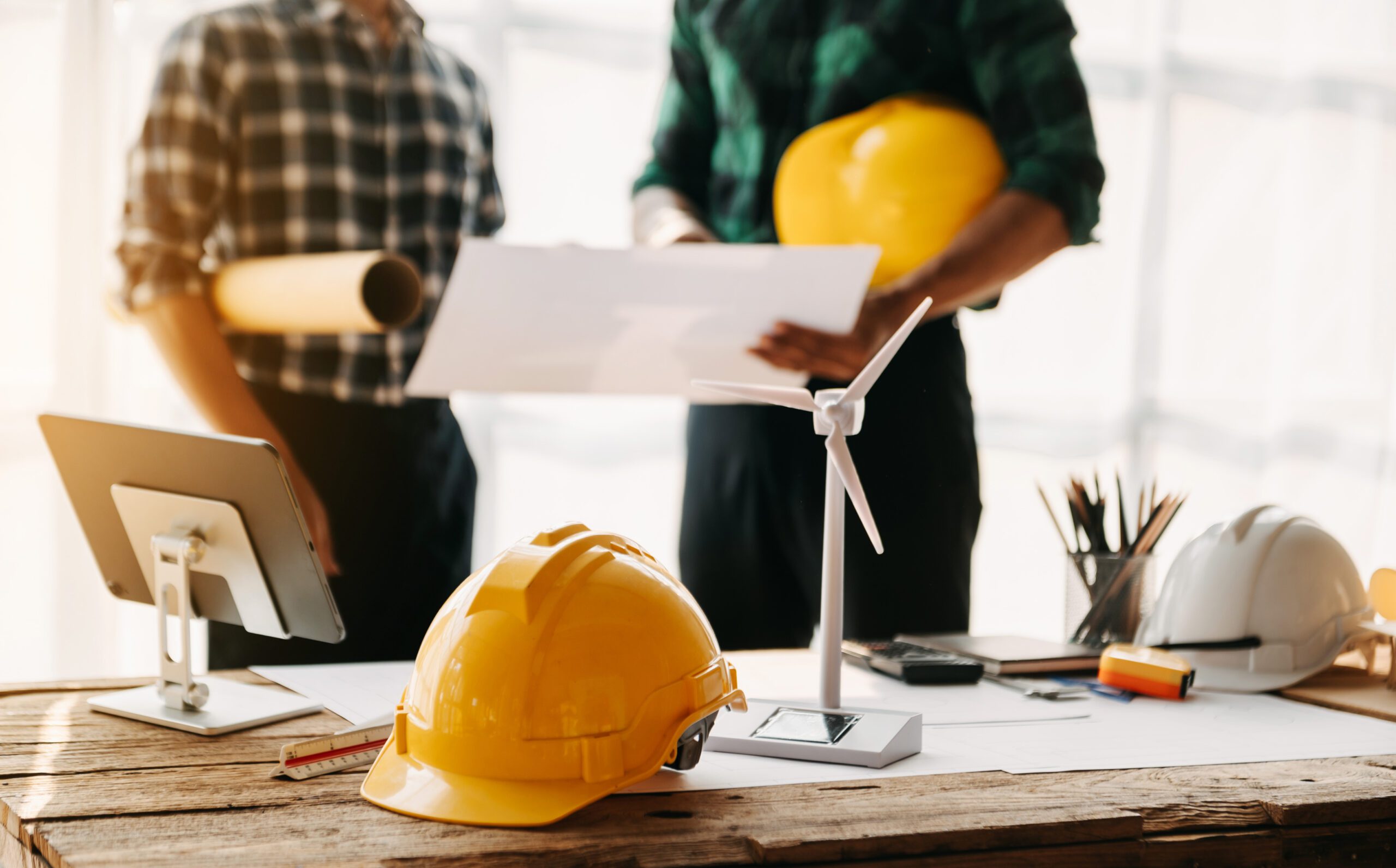 Engineer desk with object paper and tablet with blurry engineer